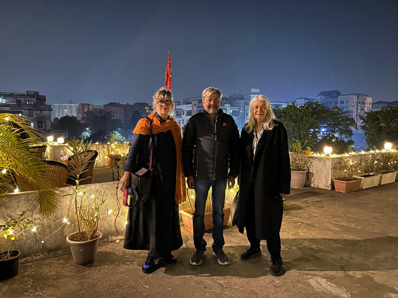 International tourists with Bhati Tours representative enjoying a rooftop evening during inbound tour operator India travel experience